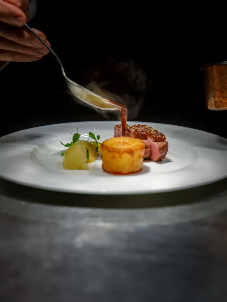 Private chef plating a dish