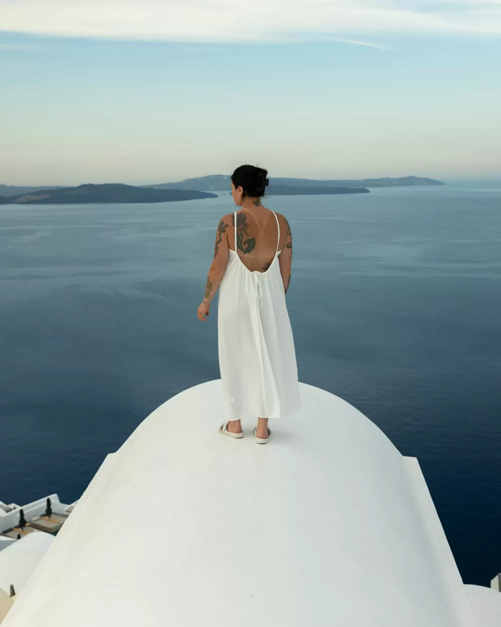 Bride on a Santorini rooftop above the Aegean